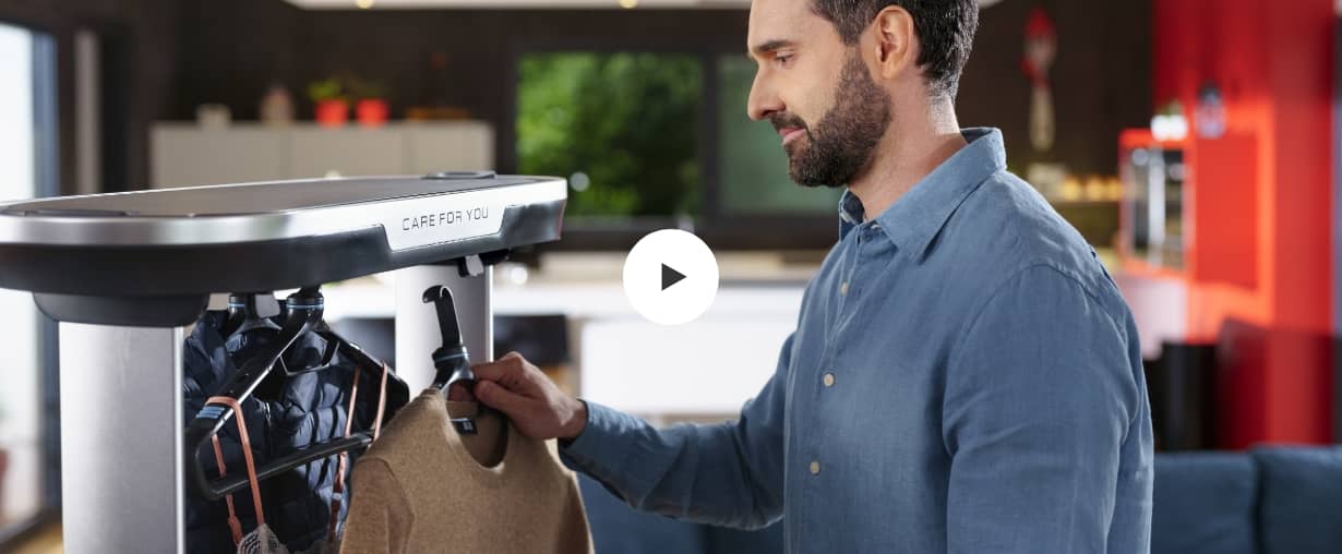 Man hanging clothes in the Care for you - click to play video